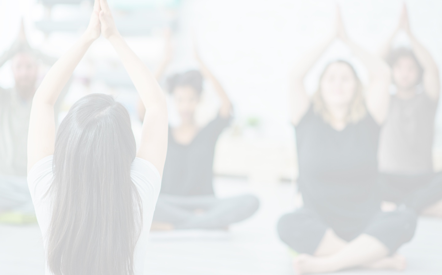 medium distance view of people posing in a yoga class